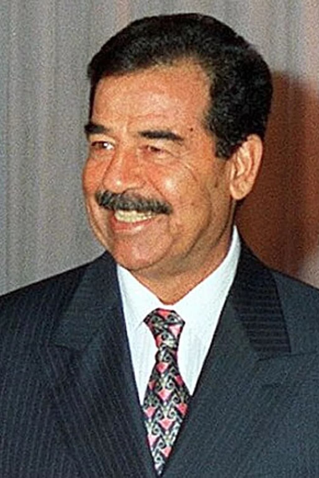 Portrait photograph of Saddam Hussein
